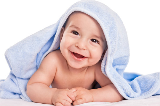 Beautiful smiling baby child after shower isolated on white
