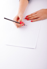 Woman writing on white sheet
