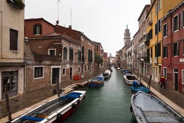 Venice canal and houses in rainy winter day