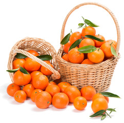 ripe tangerines with green leaves in a two basket