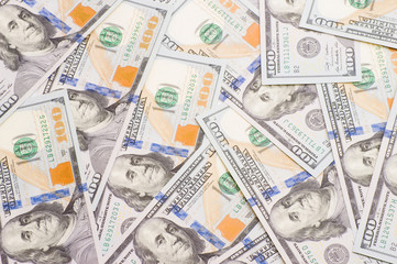 pile of hundred dollar bills laid as background