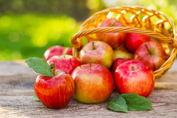 Ripe apples on wooden table, on nature background