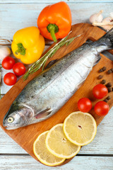 Fresh raw fish and food ingredients on table