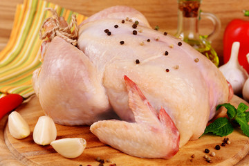 Raw chicken on wooden table