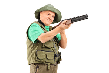Mature hunter aiming with a shotgun