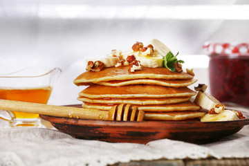 Stack of pancakes with mint, walnuts and slices of banana