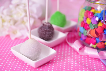 Sweet cake pops on table on bright background