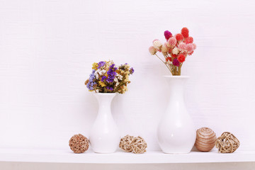 Composition of dried flowers on white wall background