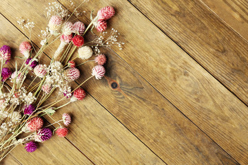 Dried flowers on rustic wooden planks background