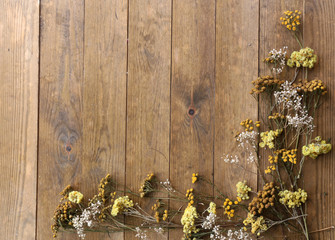 Dried flowers on rustic wooden planks background