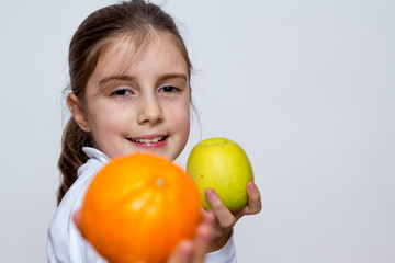 Fototapeta na wymiar Little girl playing with orange fruits