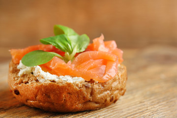 Canape with salmon and herbs on wooden background