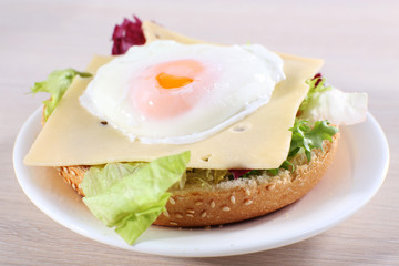 Sandwich with poached egg, cheese and greens