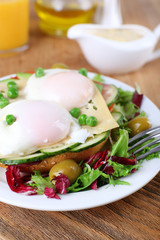 Sandwich with poached eggs, cheese and vegetables