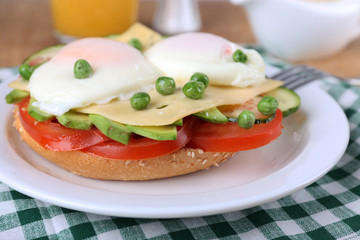 Sandwich with poached eggs, cheese and vegetables
