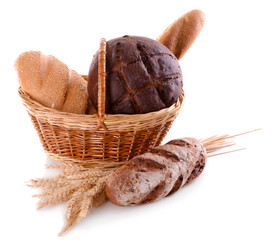 Different bread in wicker basket isolated on white