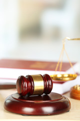 Wooden judges gavel on wooden table, close up