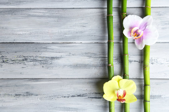 Fototapeta Orchid flowers  and bamboo with pile stones on wooden