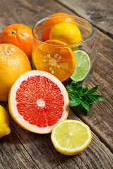 Halves of citrus fruits on wooden background. Orange, grapefruit