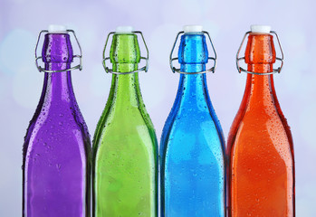 Colorful bottles on light background