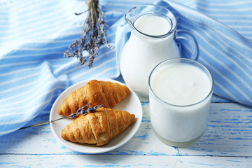 Homemade yogurt in jug and tasty croissants