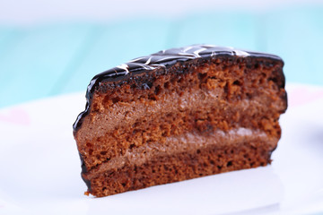 Delicious chocolate cake on plate on table close-up