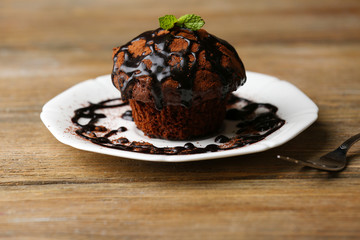Yummy chocolate cupcake on table