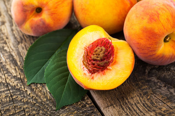 fresh peaches on wood background