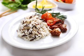 Tasty rice with meat served on table, close-up