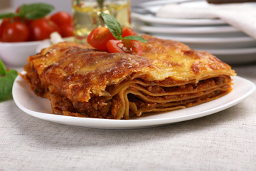 Portion of tasty lasagna on table
