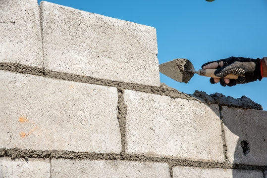 Worker Build Concrete Wall By Cement Block And Plaster 