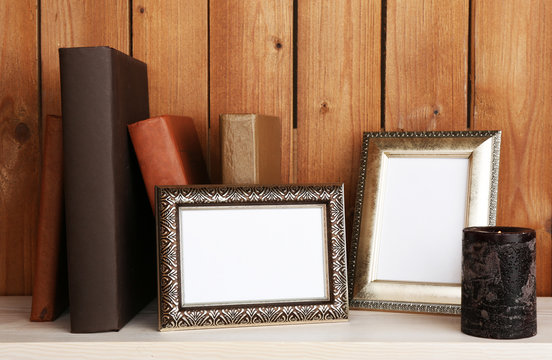 Photo frames with candle and books