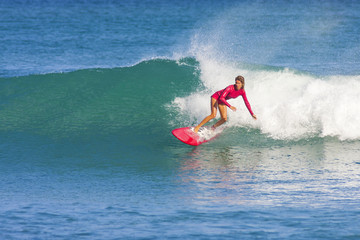 Surfer girl on the wave, Indonesia. © truphotovideo
