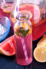 Fototapeta na wymiar Pink lemonade in glasses on table close-up