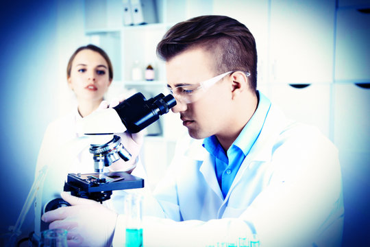 Young researcher carrying out scientific research in lab