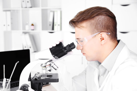 Young male researcher carrying out scientific research in lab