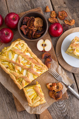 Apple pie on a board with fresh apples
