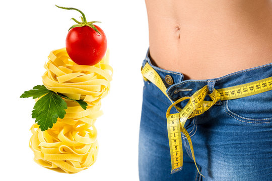Young woman wearing jeans  after diet and food background 