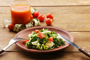 Salad with quail egg and basil in plate