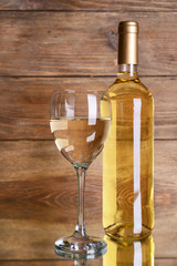 White wine on table on wooden background