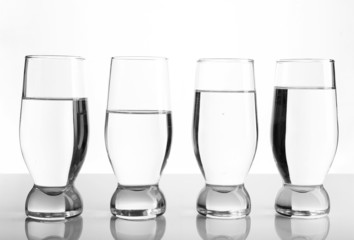Glasses of water on light background