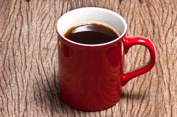 A cup of coffee on wood background