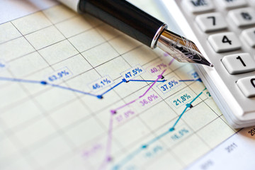 finance and business - financial graph in office