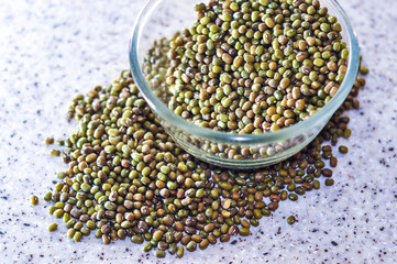 Group of green nuts and glass bowl.
