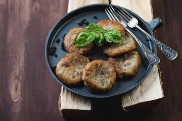 Potato pancakes or draniks in a frying pan, studio shot