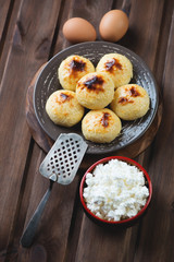 Curd pancakes over rustic wooden background, studio shot
