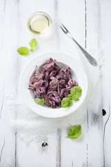 Octopuses with vegetable oil and fresh green basil, above view