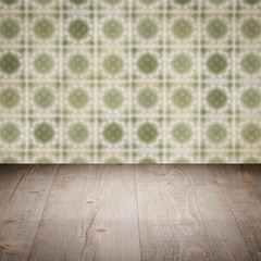 Wood table top and blur vintage ceramic tile pattern wall