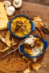 Moshroom casserole in a blue ceramic pot