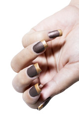 Hand with brown and gold color nail varnish